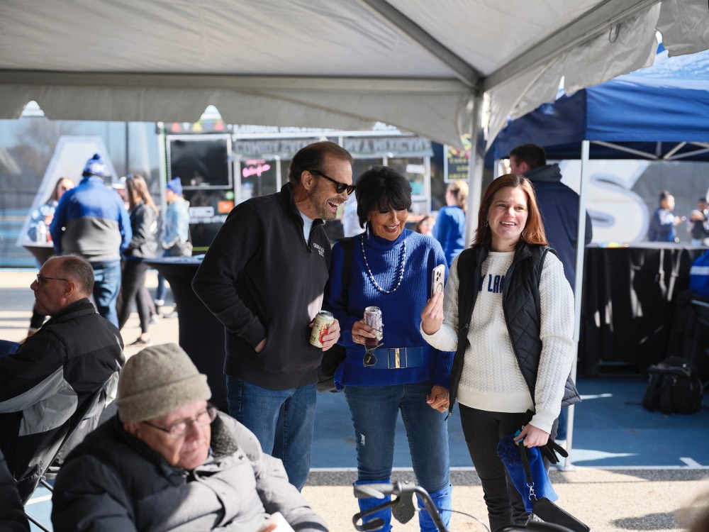 Woman showing President Mantella and man her phone